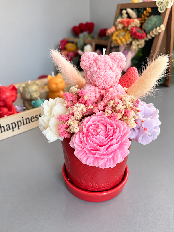 Pink bear in middle of pink flowers